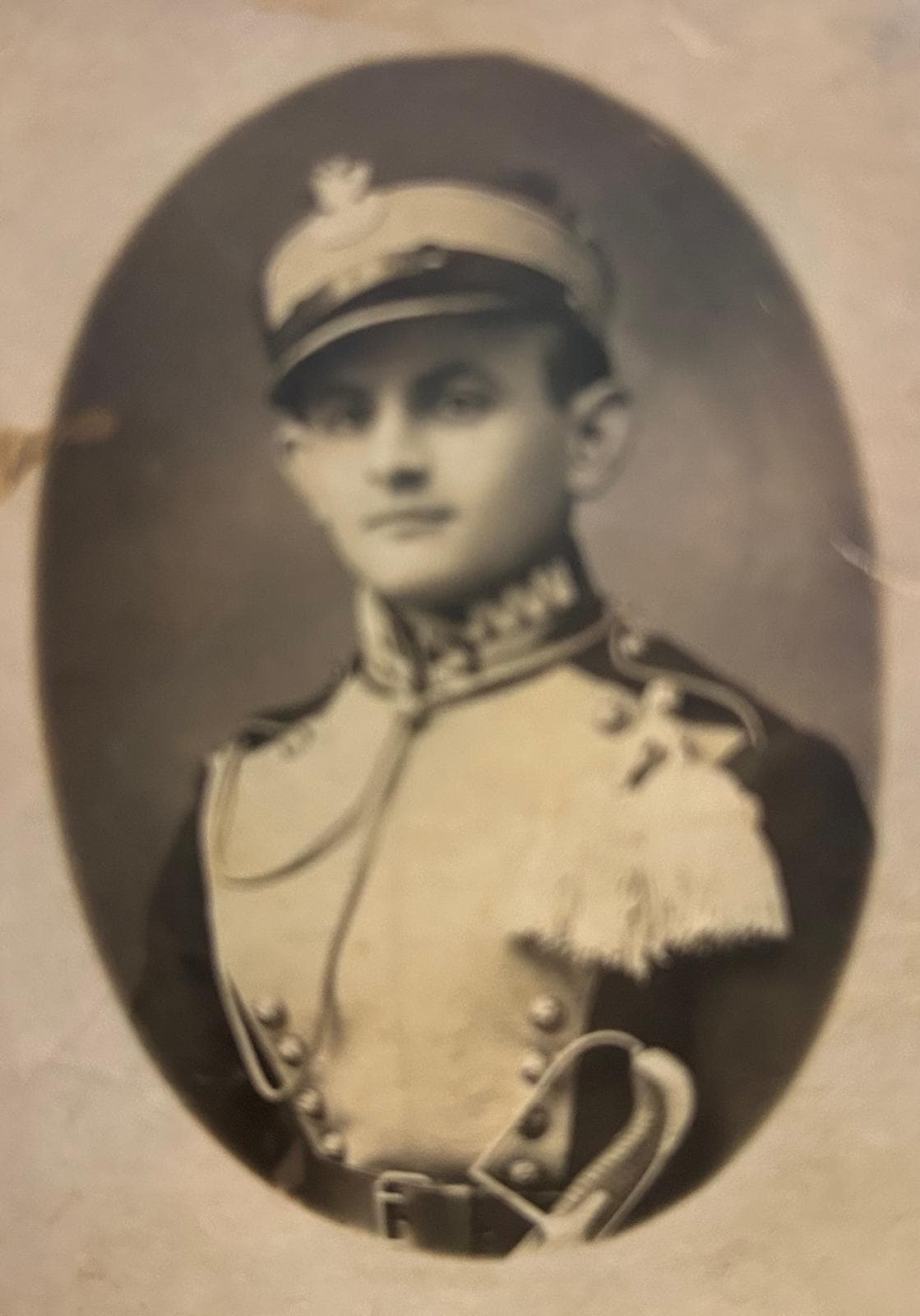 Faded oval portrait of a young soldier in dress uniform